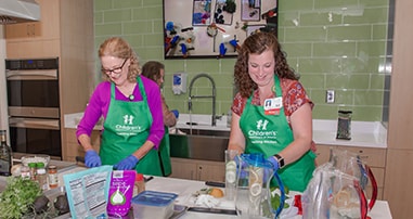 Nurses make food in the Children’s teaching kitchen.