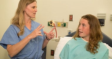 Doctor speaking with teenage patient