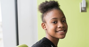 girl smiling in green room