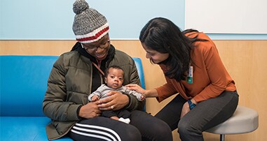 doctor meeting with infant and parent