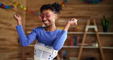 Teen girl with a scoliosis brace dancing 