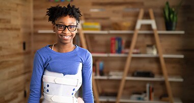 Scoliosis patient in a brace smiling.