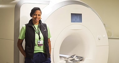 Pediatric radiology team member prepares MRI machine.