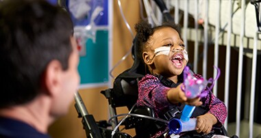 girl patient laughing in pediatric rehab