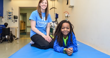 Girl patient with physical therapist