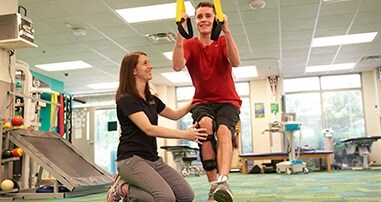 pediatric physical therapist working with teen patient