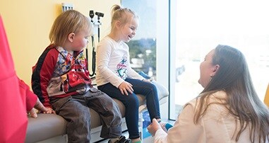 Urologist talking to two kids