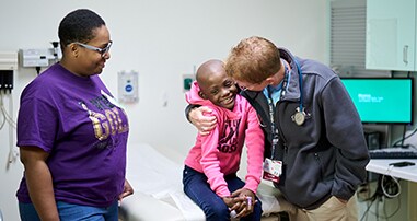 Parent with child and doctor in clinic room