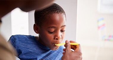 Mom giving medicine safely to child