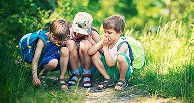 kids in woods with plants