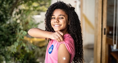 girl smiling after getting covid vaccine