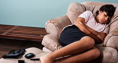 Boy lying in chair suffering from hypoglycemia
