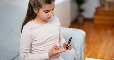 Child checking their blood sugar