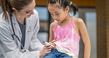 Doctor administering insulin for patient