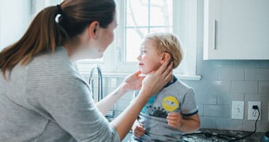 mom safely cleaning child's ears