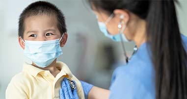 nurse checking a patient's heart with stethoscope