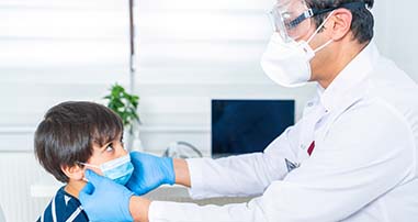 Physician adjusting child's mask