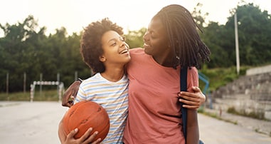 Mom with teen smiling with basketball