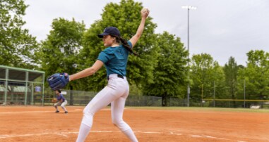 Girls softball player pitching
