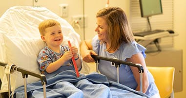 boy eating popsicle after surgery