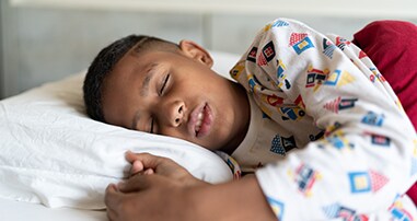 boy in white pajamas sleeping