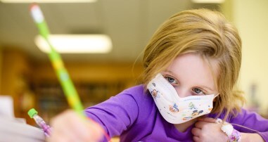 pediatric school program participant holding pencil