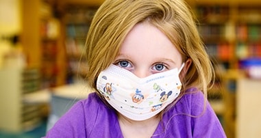 cystic fibrosis patient wearing mask in pediatric hospital