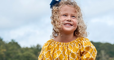 Girl with pediatric c diff smiling with parents