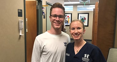 Caleb Meadows Teen boy with limb foot deformity smiling with pediatric orthopedist