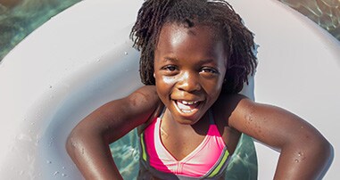 Alt Text: Sickle cell patient playing in the pool