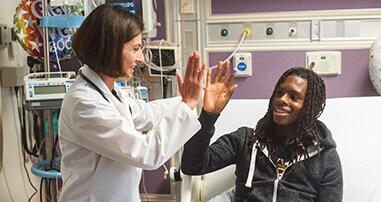 Doctor high fiving patient