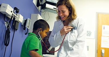 patient listening to doctor's heart beat with a stethoscope