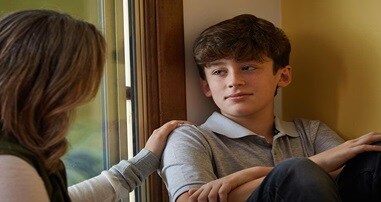 Mom comforting teen boy