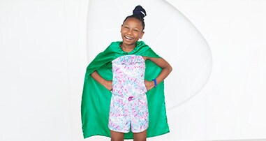 Smiling girl wearing cape