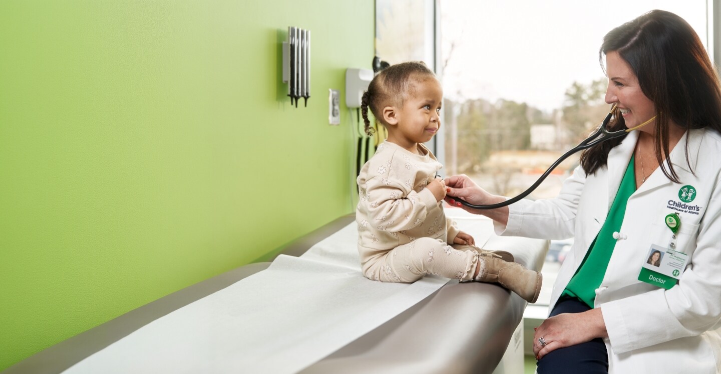doctor listens to child's heart