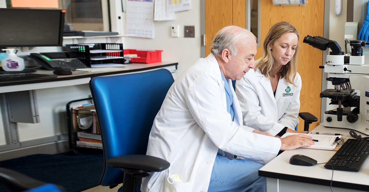 Dr. Reisner and researcher in lab.