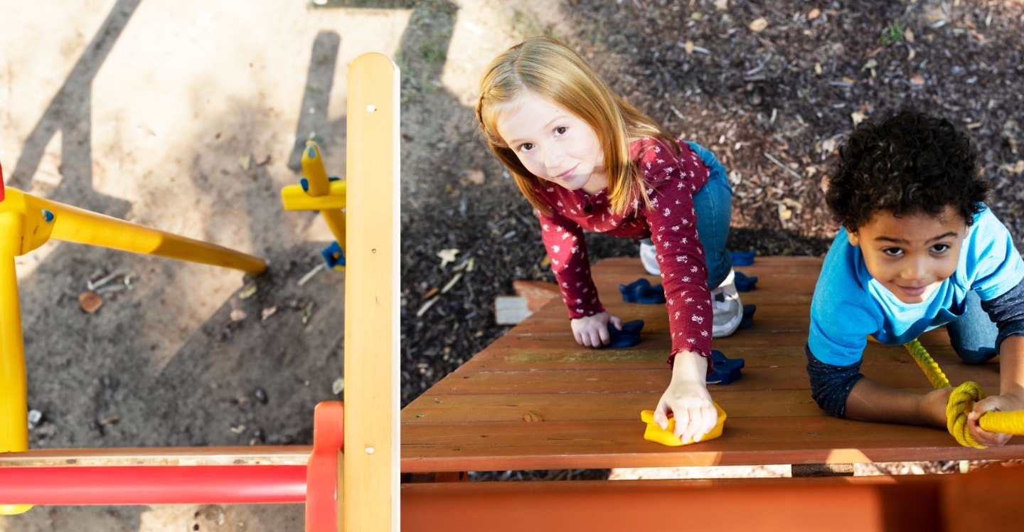Toddlers climbing rock wall