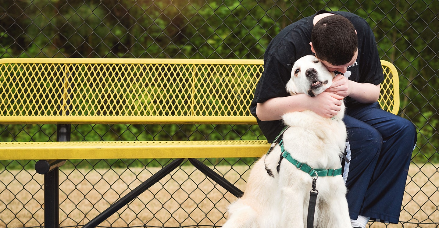autism patient hugging therapy dog