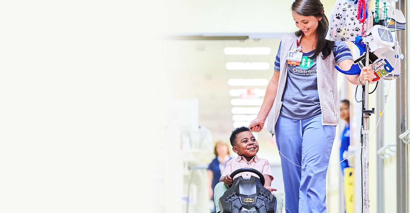 nurse walking pediatric heart patient down the hall