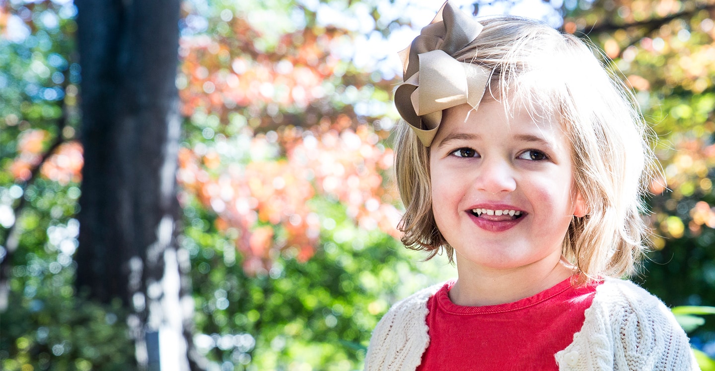 Pediatric autism patient smiling in garden