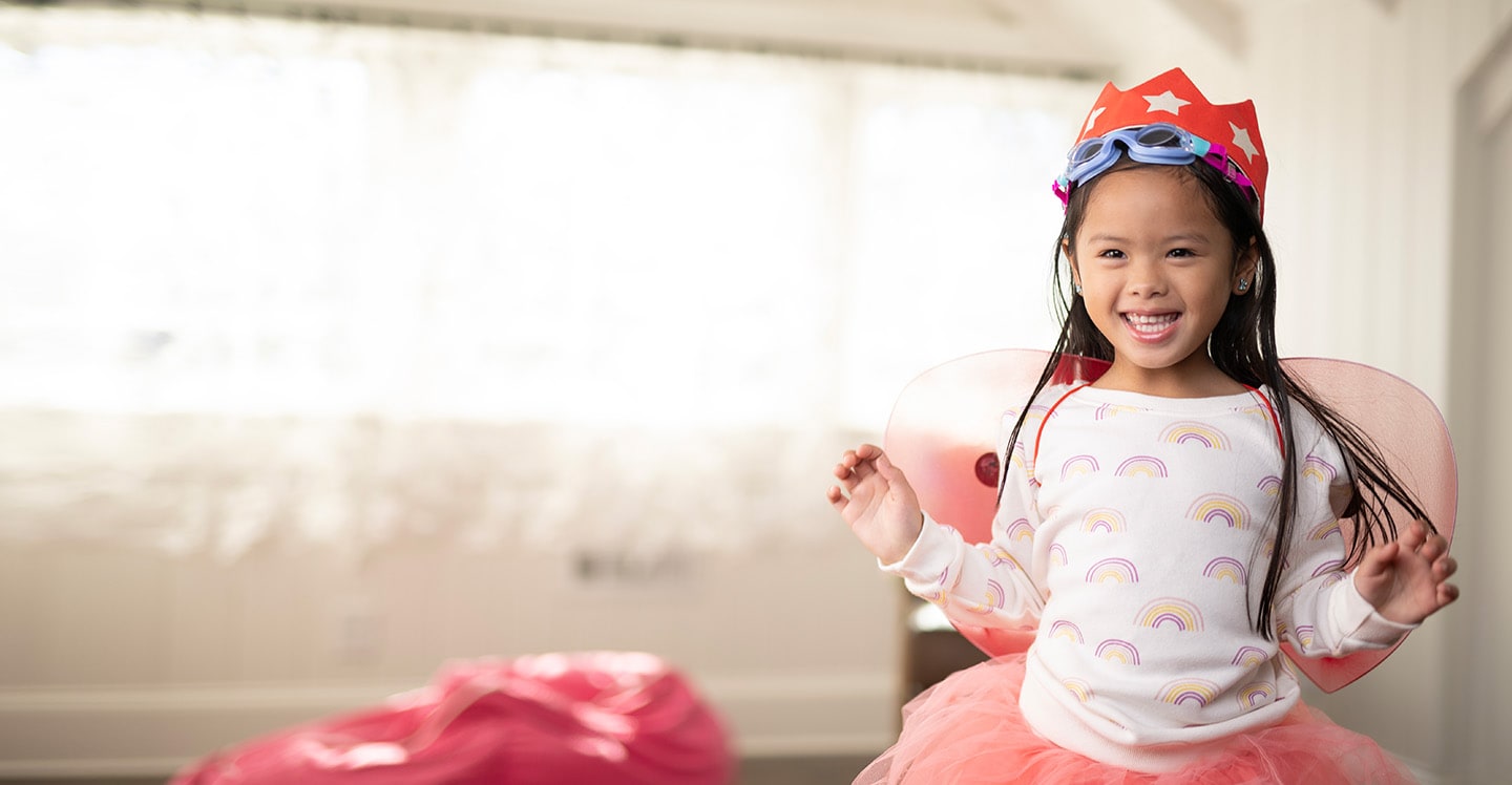 girl smiling in crown and goggles