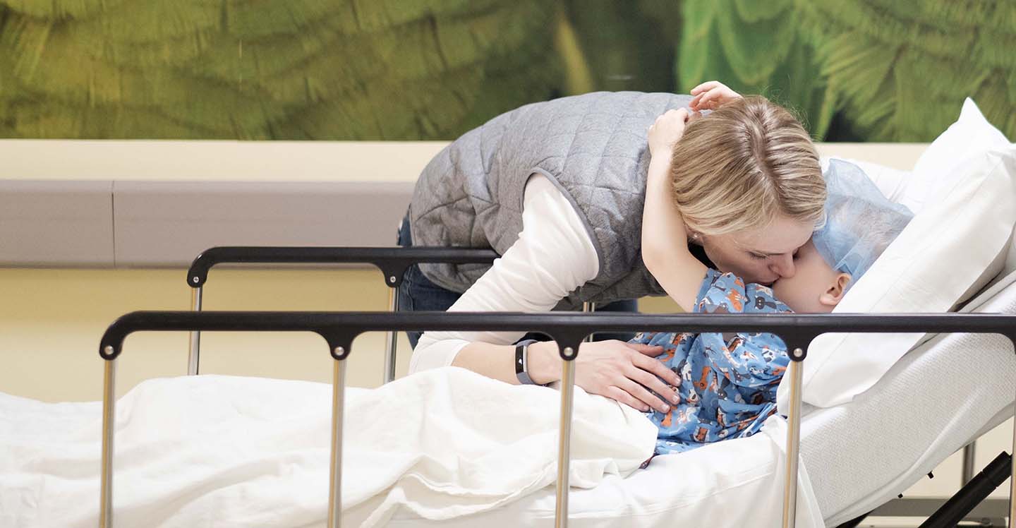 nurse hugging patient in hallway