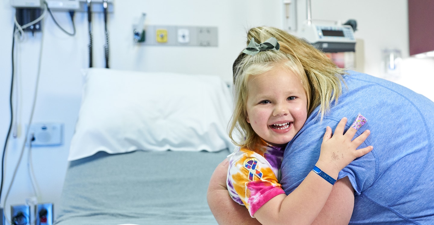 pediatric patient hugging mom in hospital room
