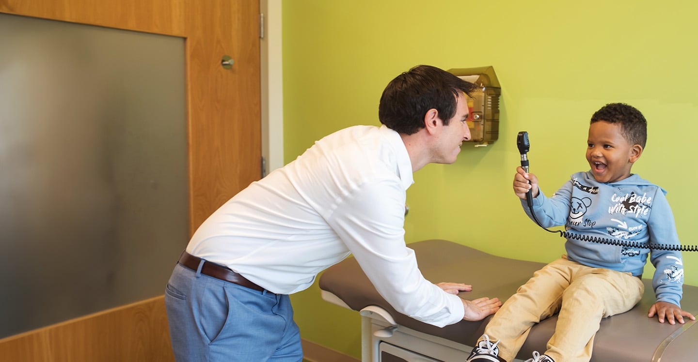 Boy and doctor with ophthalmoscope