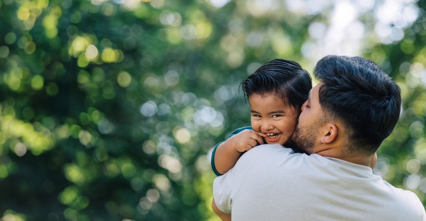Child giving their father a hug