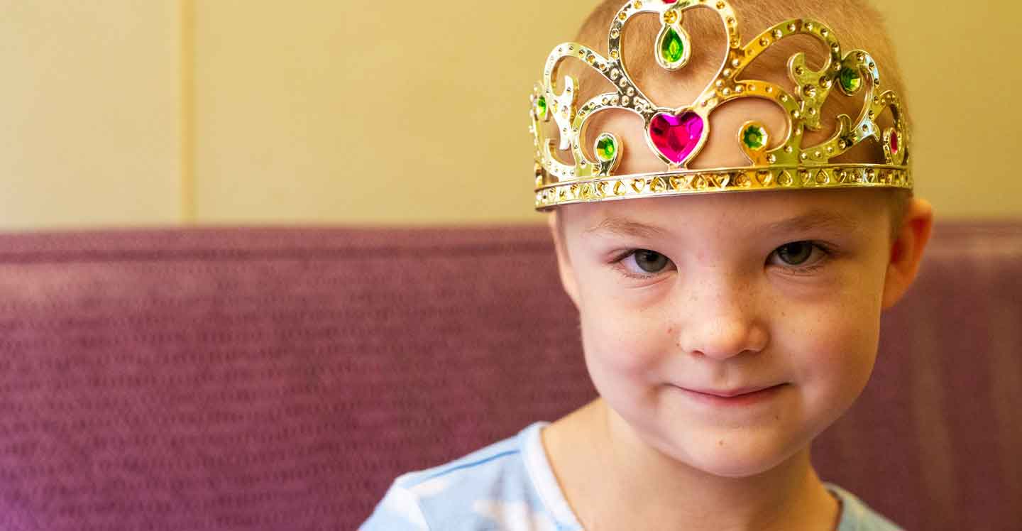 young girl cancer patient smiling wearing a princess tiara