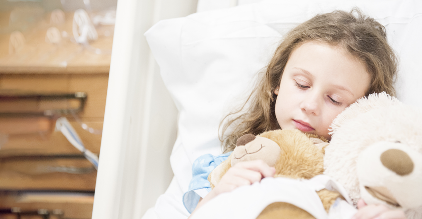 young girl sleeping with teddy bear