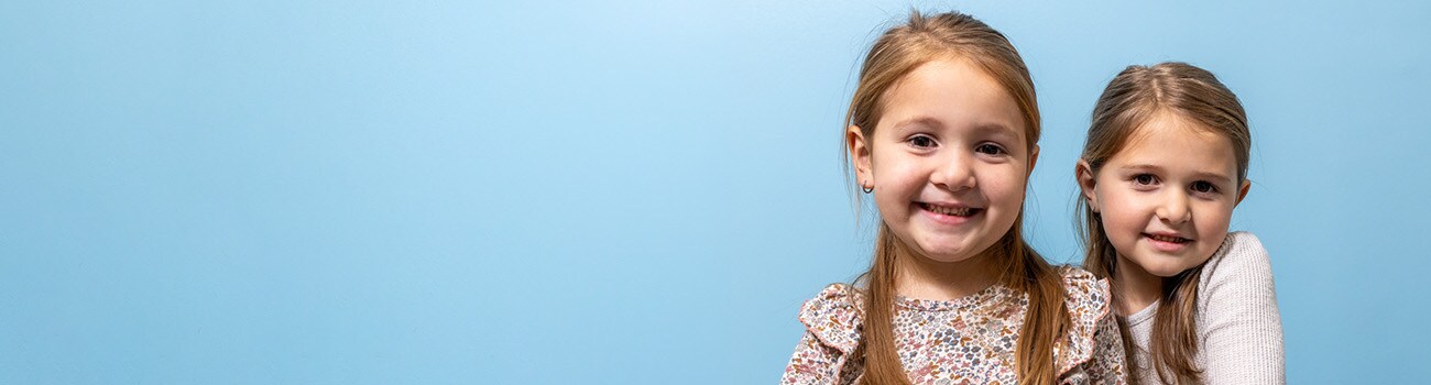 Toddler sisters in pediatrician office