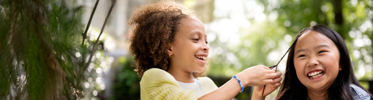 Elementary aged girls braiding hair