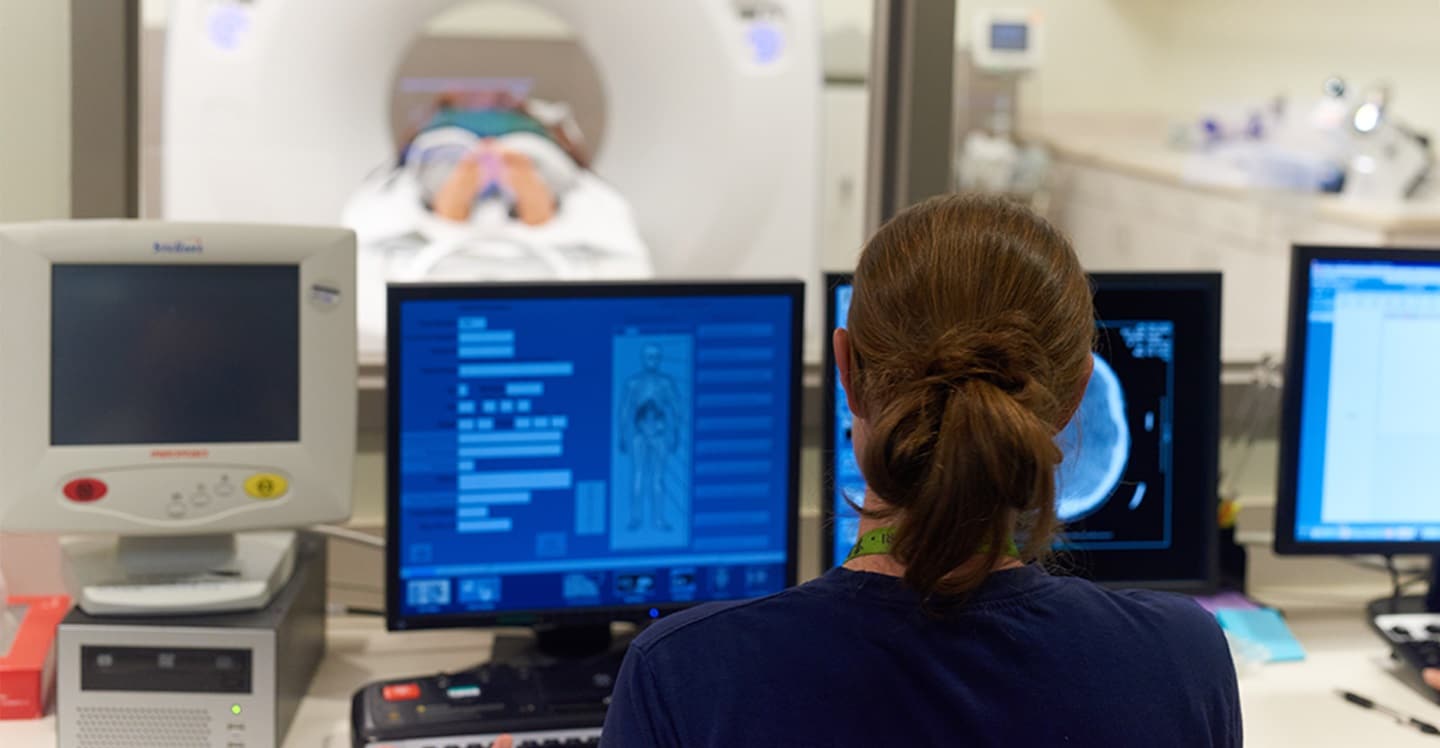 Children’s staff looking at computer screen while conducting CT scan